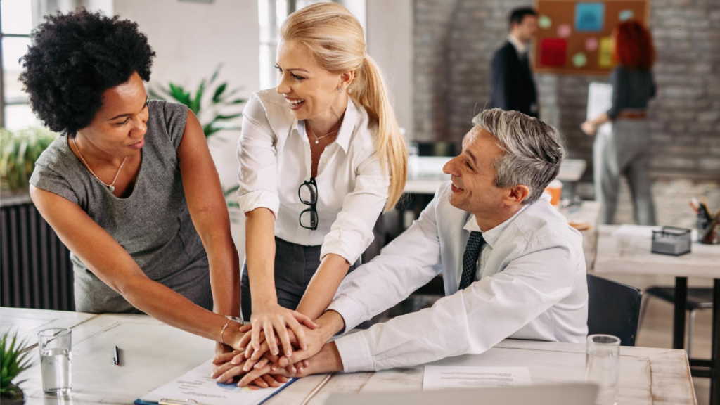 Team of professionals celebrating a unified goal, demonstrating the team spirit in a sponsored multicultural workplace